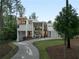 Modern home with clean lines, multiple balconies, and a long driveway, surrounded by trees at 2650 Fairoaks Rd, Decatur, GA 30033