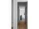 Hallway with hardwood floors leading to a modern bathroom with stylish fixtures and finishes at 2650 Fairoaks Rd, Decatur, GA 30033