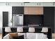 Modern kitchen with black and wood cabinets, marble backsplash, stainless appliances, and island seating at 2650 Fairoaks Rd, Decatur, GA 30033