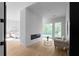 Open-concept living area with fireplace, deck access, and hardwood floors leading to adjacent bedroom at 2650 Fairoaks Rd, Decatur, GA 30033