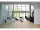 Light-filled living room boasts floor-to-ceiling windows, fireplace and modern kitchen with breakfast bar offers seamless indoor-outdoor living at 2650 Fairoaks Rd, Decatur, GA 30033