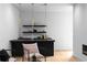 Chic wet bar area with dark countertop, floating shelves and sleek lighting in a bright room at 2650 Fairoaks Rd, Decatur, GA 30033