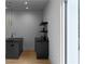 Stylish wet bar area with shelving, dark countertop and sink near a large window at 2650 Fairoaks Rd, Decatur, GA 30033