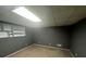 A view of the basement showing the carpeted floor, walls and built-in shelving above a small window at 350 Spring View Ct, Dallas, GA 30157