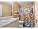 Bathroom showcasing a sink, mirror, and colorful floral shower curtain at 350 Spring View Ct, Dallas, GA 30157