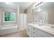 Bright bathroom featuring double sinks and vanity plus soaker tub and window at 350 Spring View Ct, Dallas, GA 30157