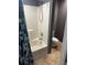 Bathroom featuring a shower-tub combo, patterned shower curtain, and neutral tiling at 350 Spring View Ct, Dallas, GA 30157