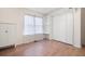 Bright bedroom features built-in shelving, closet, wood floors, and natural light from a window at 350 Spring View Ct, Dallas, GA 30157