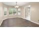Bright dining room featuring hardwood floors, windows, and a chandelier, offering a welcoming space for Gathering meals at 350 Spring View Ct, Dallas, GA 30157