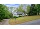 Street view of the house with a sloped front yard with mature trees at 350 Spring View Ct, Dallas, GA 30157