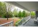 Comfortable front porch with wood flooring, white railings, and outdoor seating at 350 Spring View Ct, Dallas, GA 30157