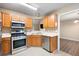 Kitchen featuring stainless steel appliances and natural wood cabinets at 350 Spring View Ct, Dallas, GA 30157