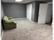 Carpeted living room featuring a green couch and access to a doorway and closet at 350 Spring View Ct, Dallas, GA 30157