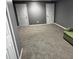 Spacious carpeted living room featuring a green couch and several doorways at 350 Spring View Ct, Dallas, GA 30157