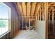 Unfinished attic space with a window, wood framing, and plywood flooring at 362 Mcgiboney Rd, Covington, GA 30016