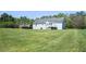 Spacious backyard with lush green lawn and a wooden deck, perfect for relaxation and outdoor activities at 362 Mcgiboney Rd, Covington, GA 30016