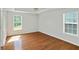 Spacious bedroom with hardwood floors, large windows, and a ceiling fan at 362 Mcgiboney Rd, Covington, GA 30016