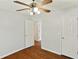 Bedroom with hardwood floors, ceiling fan, and white doors at 362 Mcgiboney Rd, Covington, GA 30016