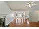 Expansive living room showcasing hardwood floors, fireplace, access to the kitchen and large windows at 362 Mcgiboney Rd, Covington, GA 30016