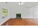 Bright living room featuring hardwood floors, a white ceiling fan, a fireplace and large windows at 362 Mcgiboney Rd, Covington, GA 30016