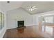 Spacious living room with hardwood floors, a fireplace with green tiles, and abundant natural light at 362 Mcgiboney Rd, Covington, GA 30016