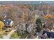 Beautiful aerial view of home with well-manicured lawn surrounded by mature trees at 760 Woodrow Dr, Lawrenceville, GA 30043