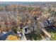 Stunning aerial view of the home featuring a large driveway, well-maintained lawn, and beautiful fall foliage at 760 Woodrow Dr, Lawrenceville, GA 30043