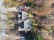 Overhead view of home with a dark roof and a patio space in the back, surrounded by trees at 760 Woodrow Dr, Lawrenceville, GA 30043