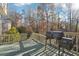 Inviting back deck with a built-in grill and a view of the lush, wooded backyard at 760 Woodrow Dr, Lawrenceville, GA 30043