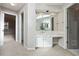 Bathroom vanity with sink, mirror, lighting, and carpet at 760 Woodrow Dr, Lawrenceville, GA 30043