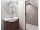 Elegant bathroom featuring a stylish vanity, an oval mirror, and a beautifully tiled walk-in shower at 760 Woodrow Dr, Lawrenceville, GA 30043
