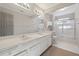 Bathroom featuring double sink vanity with white cabinets, a large mirror, and shower with sliding glass door at 760 Woodrow Dr, Lawrenceville, GA 30043