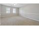 Spacious bedroom featuring neutral decor, carpeted flooring, and windows with plantation shutters at 760 Woodrow Dr, Lawrenceville, GA 30043