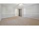 Neutral bedroom featuring carpet floors, grey walls and a double door closet at 760 Woodrow Dr, Lawrenceville, GA 30043