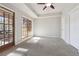 Bright bedroom featuring a large window, plush carpet, and access to an outdoor deck at 760 Woodrow Dr, Lawrenceville, GA 30043