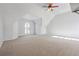 Upstairs bonus room with vaulted ceilings, neutral walls and carpeted floors at 760 Woodrow Dr, Lawrenceville, GA 30043