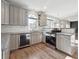 Modern kitchen with stainless steel appliances, granite countertops and light wood floors at 760 Woodrow Dr, Lawrenceville, GA 30043