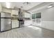 Charming kitchen with stainless steel appliances, white cabinets, and a window overlooking the backyard at 760 Woodrow Dr, Lawrenceville, GA 30043