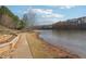 A serene lake view featuring a walking trail and small dock, surrounded by trees at 760 Woodrow Dr, Lawrenceville, GA 30043