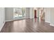 Open-concept living area featuring hardwood floors, a large window, and a view of the entrance foyer at 760 Woodrow Dr, Lawrenceville, GA 30043