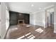 Open living room with hardwood floors, a fireplace, custom built-ins, and natural light from a large window at 760 Woodrow Dr, Lawrenceville, GA 30043