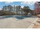 Neighborhood pool with a winter cover surrounded by tall trees at 760 Woodrow Dr, Lawrenceville, GA 30043