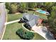 Stunning aerial view of a brick home with a spacious yard and in-ground pool in a lush, green neighborhood at 7804 Gusty Trl, Douglasville, GA 30135