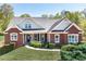 Charming brick home featuring a well-manicured lawn and classic architectural details at 7804 Gusty Trl, Douglasville, GA 30135