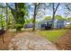 Spacious backyard with ample space for outdoor activities, featuring a grassy area, trees, and privacy fencing at 1623 Athens Sw Ave, Atlanta, GA 30310