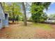 This backyard features a wooden deck, steps, lush trees and landscaping, along with a portion of the backyard at 1623 Athens Sw Ave, Atlanta, GA 30310