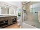 Modern bathroom showcasing a large vanity, decorative mirror, and a tiled shower-tub combination at 1623 Athens Sw Ave, Atlanta, GA 30310