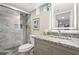 Renovated bathroom with a marble shower, granite vanity, and modern fixtures at 1623 Athens Sw Ave, Atlanta, GA 30310