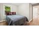 Bedroom with hardwood floors, neutral walls, and natural light from a bright window overlooking nature at 1623 Athens Sw Ave, Atlanta, GA 30310