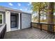 Inviting front deck made with stained lumber, a security screen door, and featuring an exterior stone facade at 1623 Athens Sw Ave, Atlanta, GA 30310